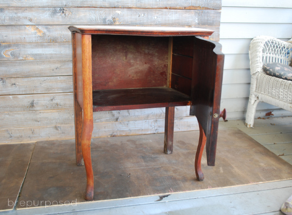 Check out how I transformed the inside of this little table with some coral paint and fabric on the inside!