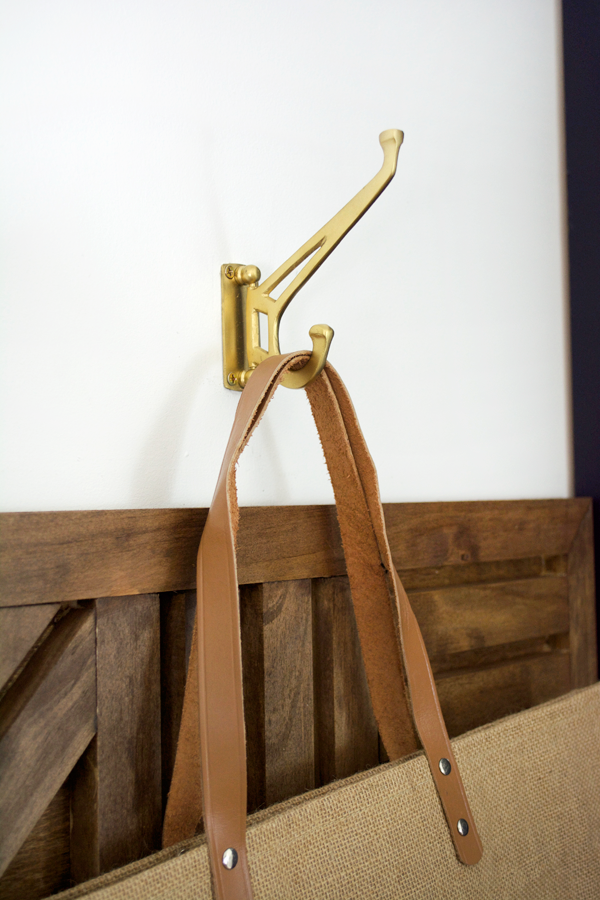 vintage brass coat hooks in a mud room