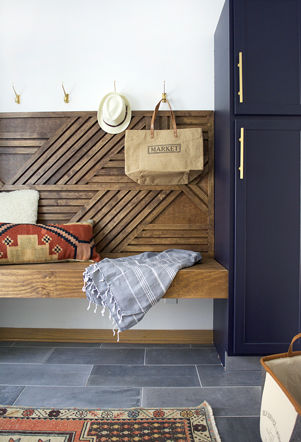 floating bench and wood feature wall in a mud room