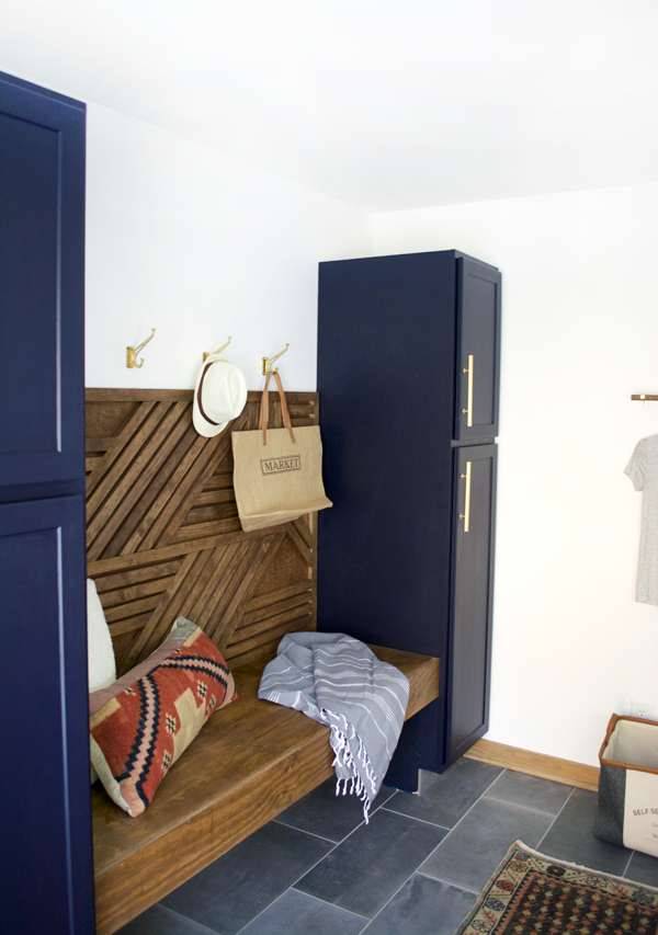 a floating bench between two cabinets in a mud room