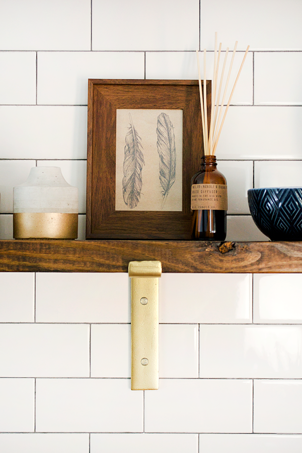 gold brackets on open shelving