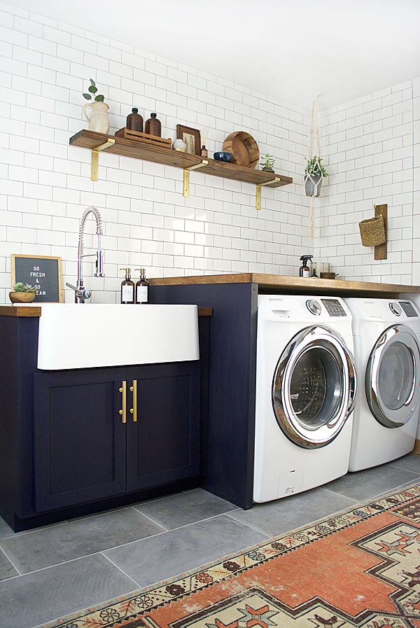 A dated space gets a dramatic update. Check out this Modern Navy Laundry and Mud Room Reveal!