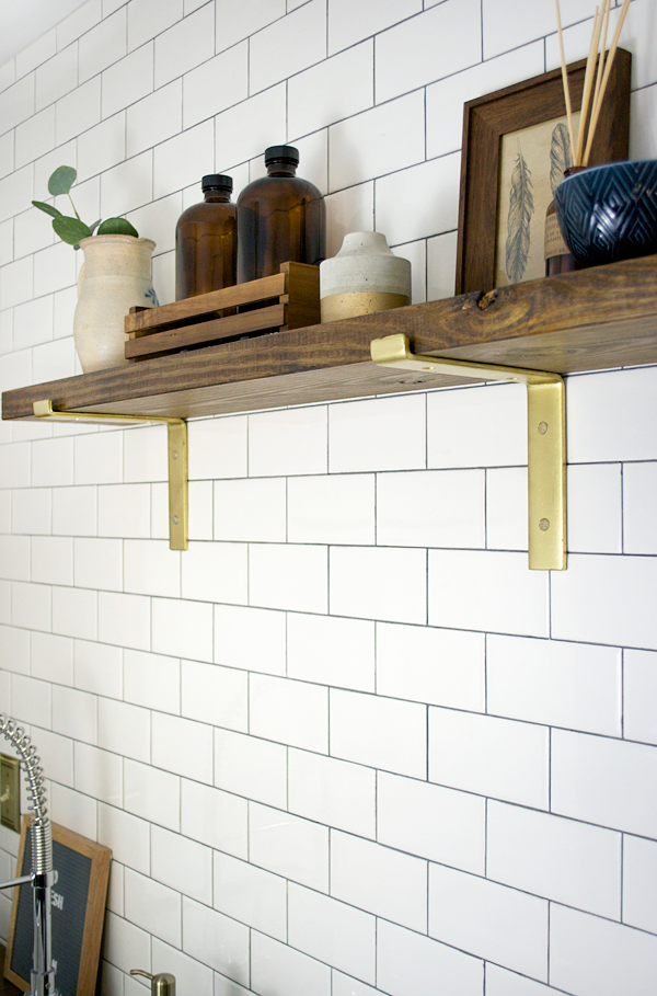 open shelving with gold brackets