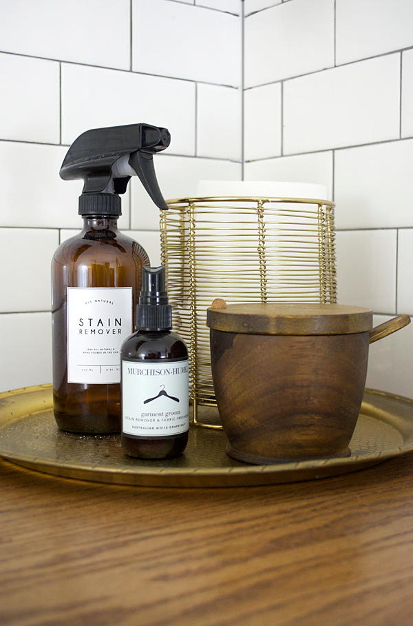 laundry room cleaning products on brass tray