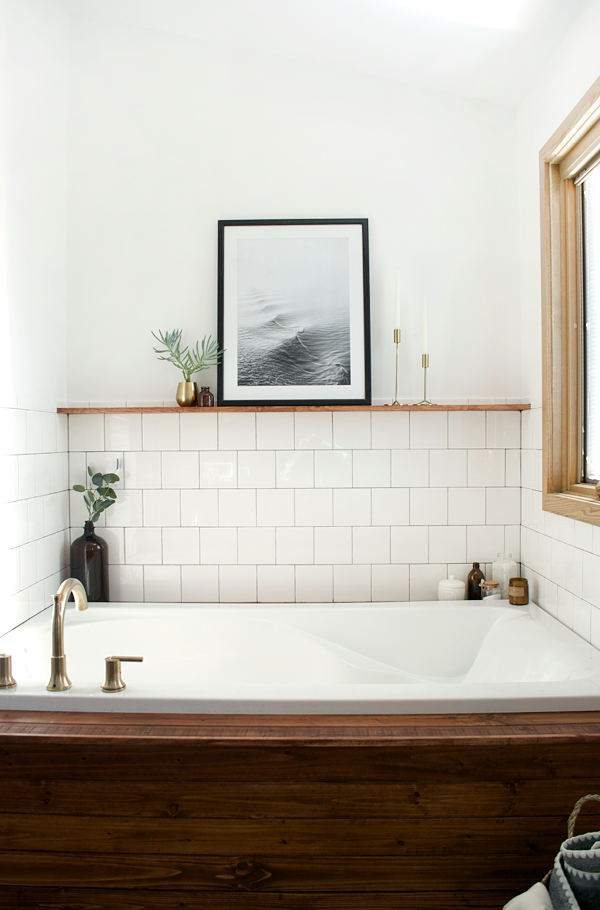 a floating wood shelf above the bathtub