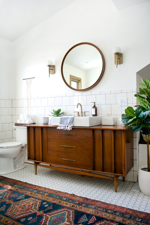 vintage rug and vanity in a modern bathroom