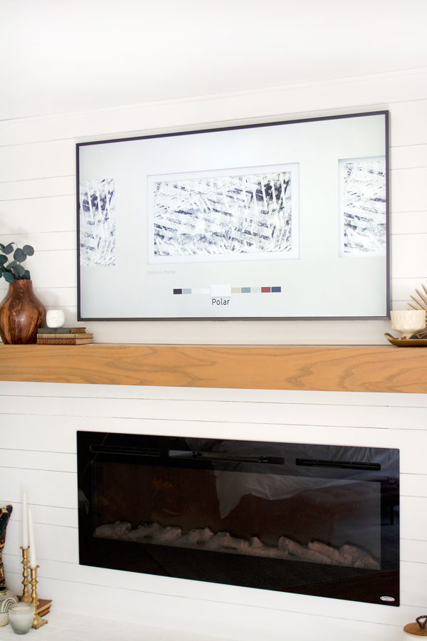 a tv that looks like art above the mantle