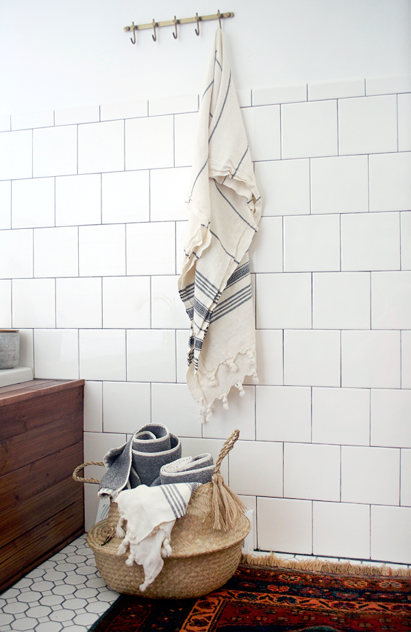 Burlap Tassels on a belly basket in the bathroom for towels