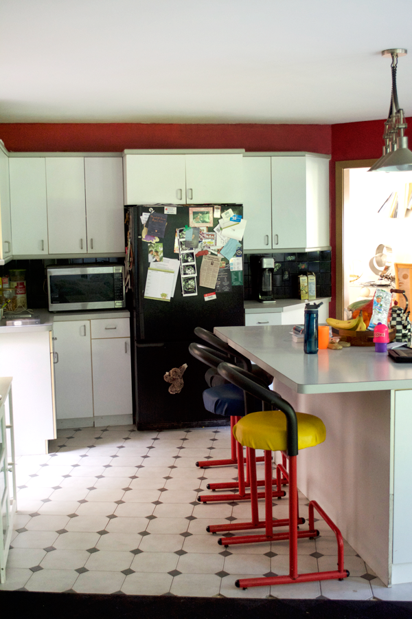 kitchen with red walls and black appliances