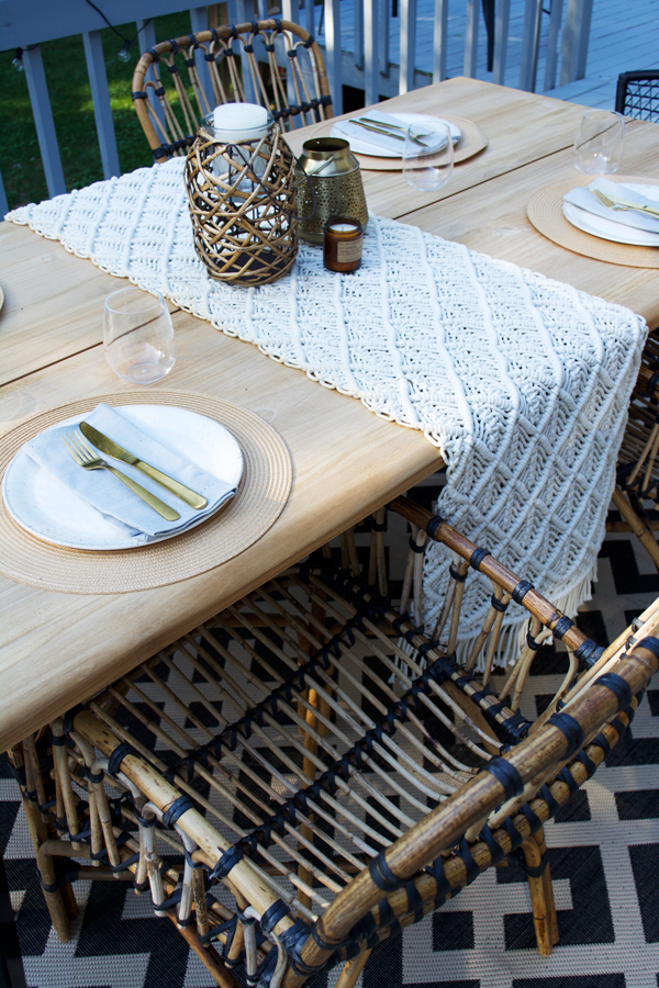 macrame table runner on an outdoor teak dining table