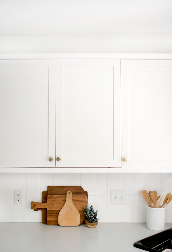 updated white kitchen cabinets with paint and trim