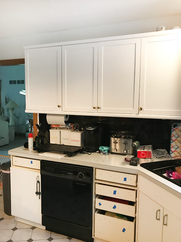 painting black tile backsplash with white paint