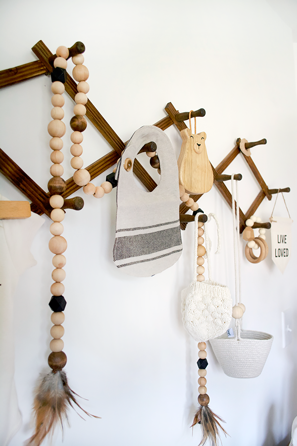 vintage accordion clothes drying rack in a modern nursery