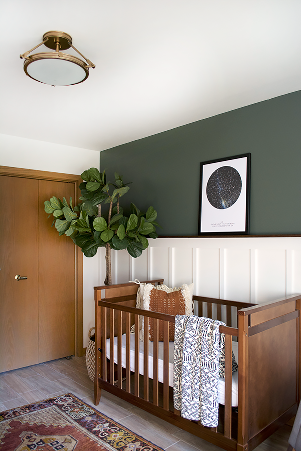 a board and batten accent wall in a modern vintage nursery