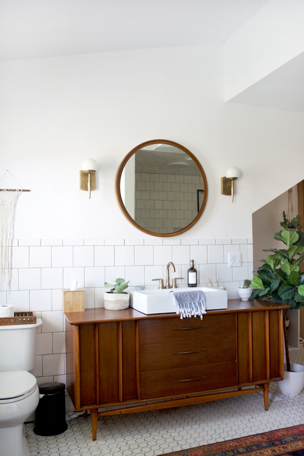 Brass faucet on a white bathroom sink