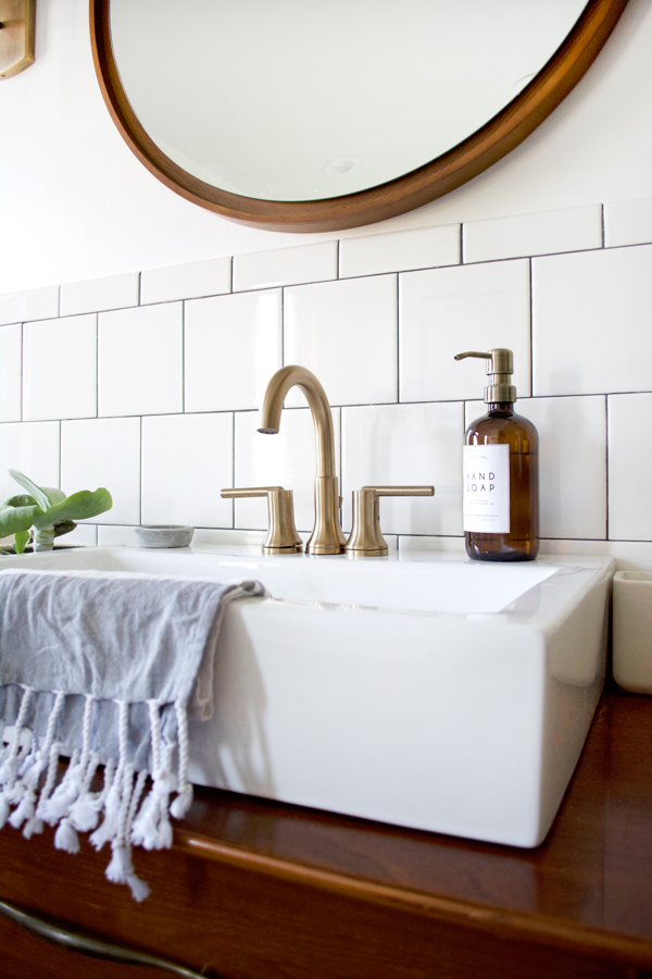 bathroom sink with brass fixtures