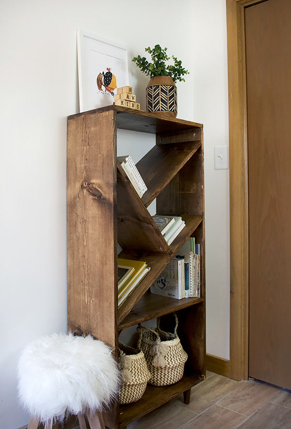 mini belly baskets on a diy bookcase with angled shelves