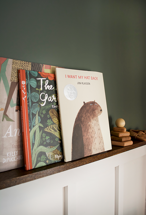 kid books leaning on a board and batten shelf in nursery