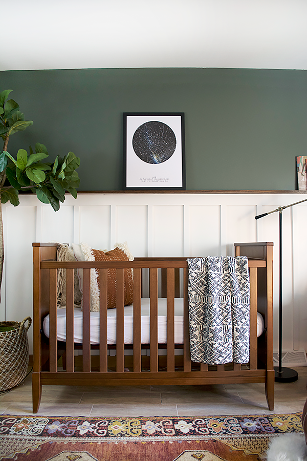 wooden crib in a modern boy's nursery