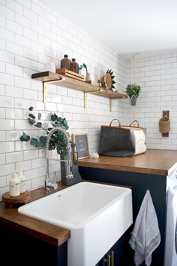 navy laundry room with white subway tile