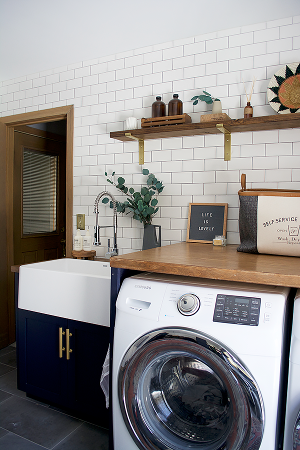 butcher block countertop in a navy laundry room