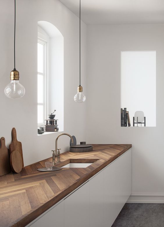 Herringbone butcher block kitchen countertop with brass accents