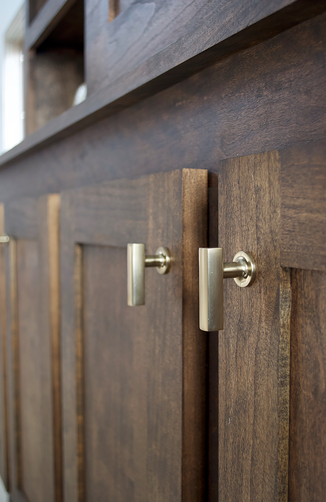 Brass Finger Pulls on Dark Wood Cabinets