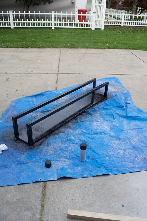 Spray paint a floating firewood rack black
