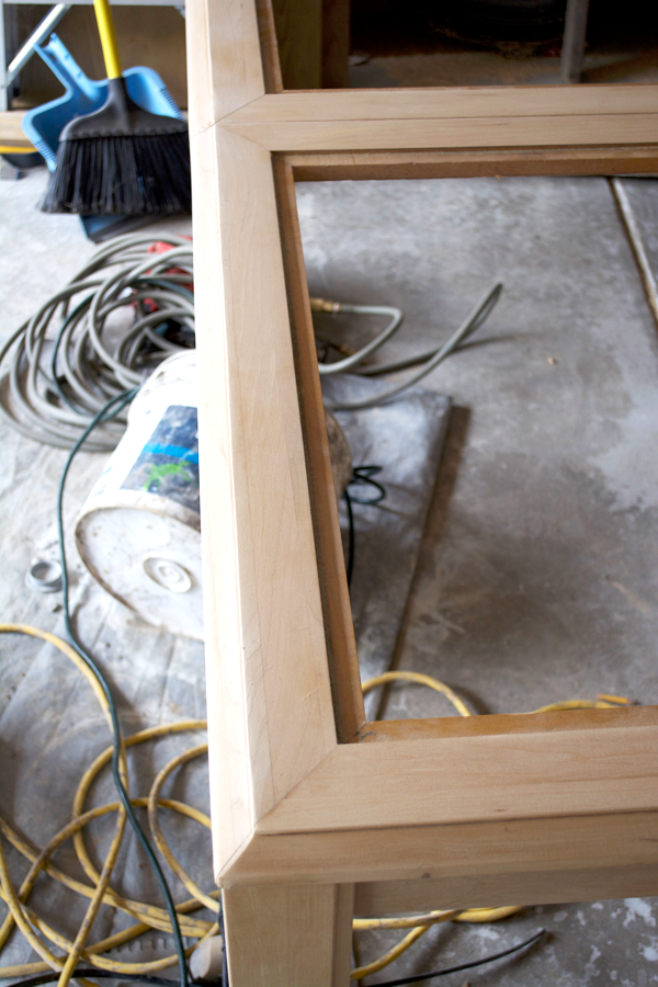 Sanding an old dining room table with an electric sander