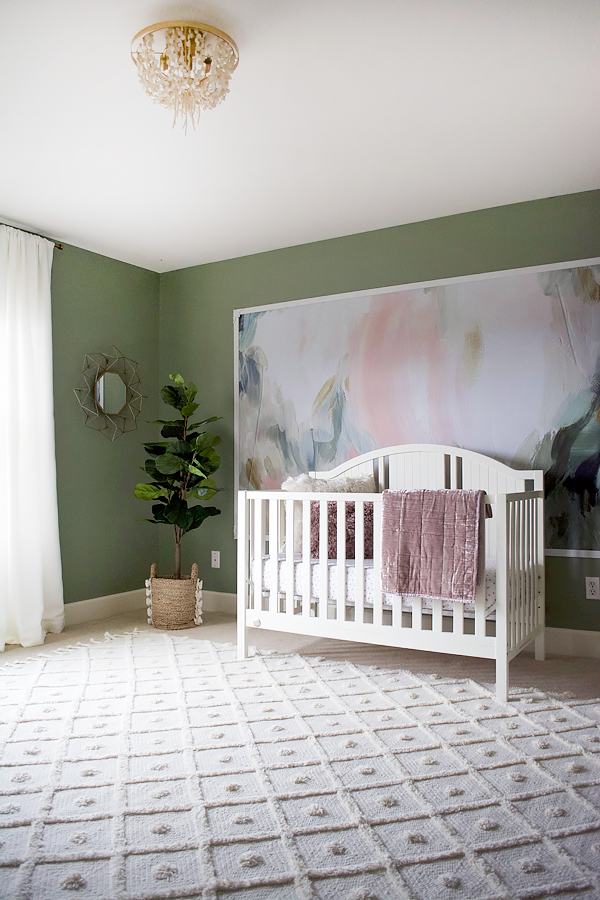 Nursery with floral wall mural and green walls
