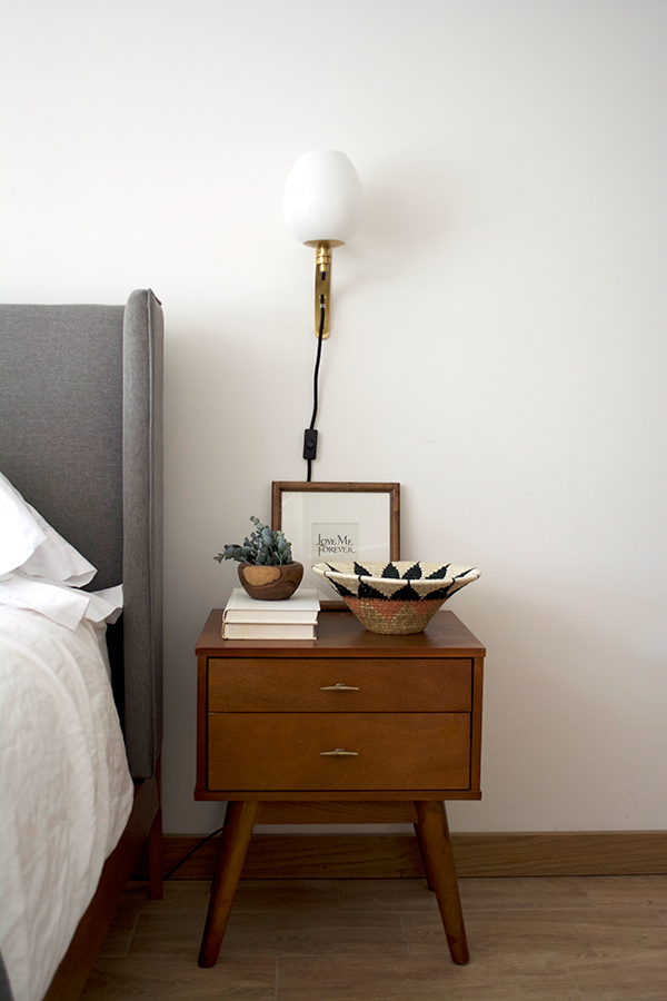 Nightstand decor with a wall sconce
