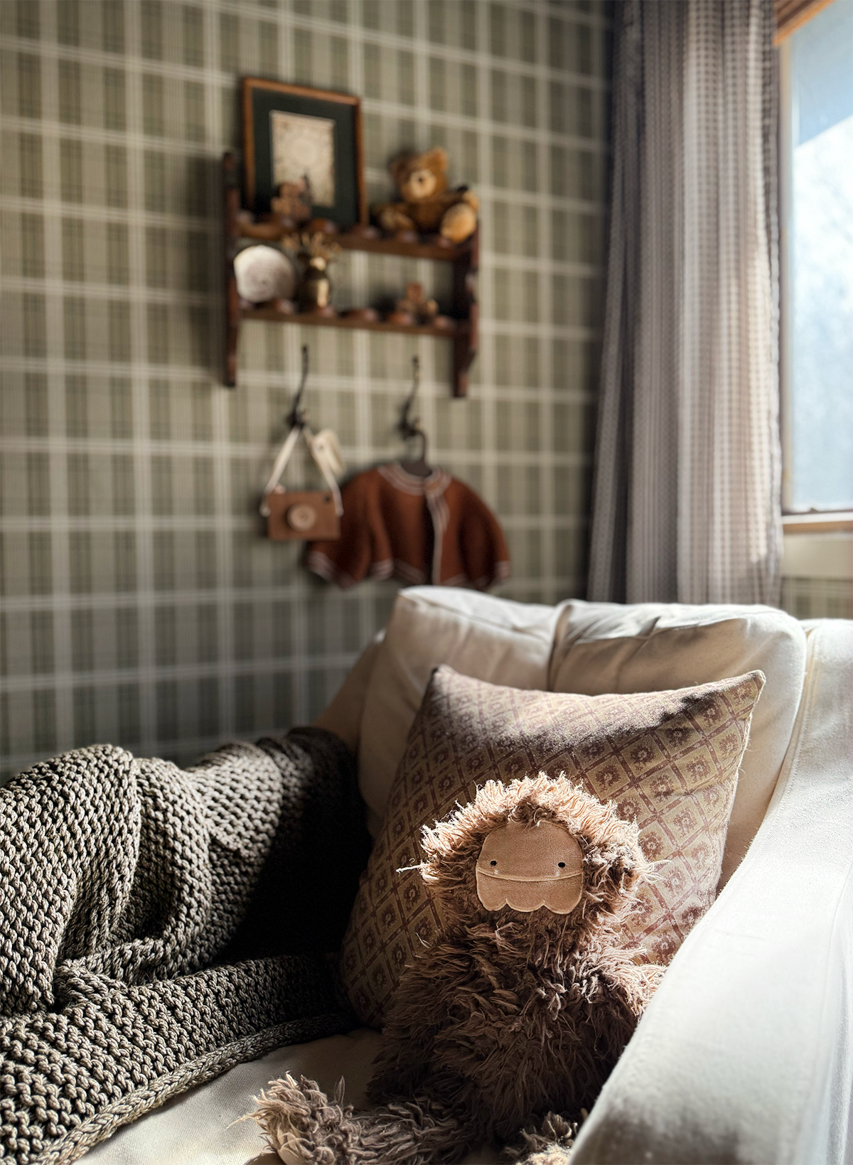 nursery chair with stuffed animal and cozy blanket