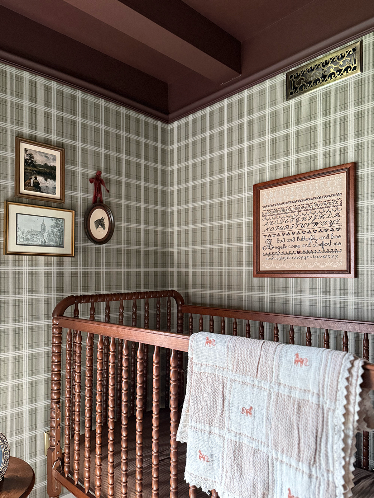vintage-inspired baby boy nursery with green plaid wallpaper