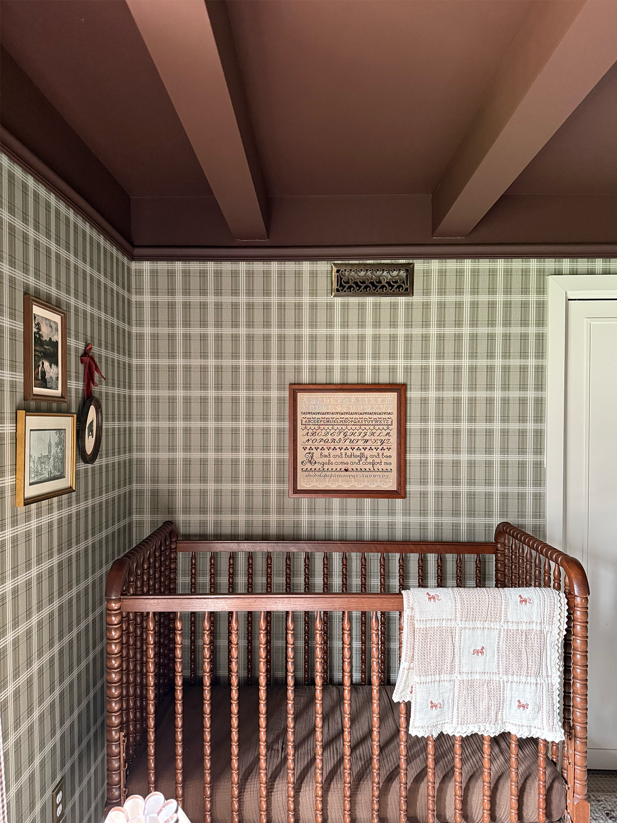 green plaid wallpaper in baby's nursery